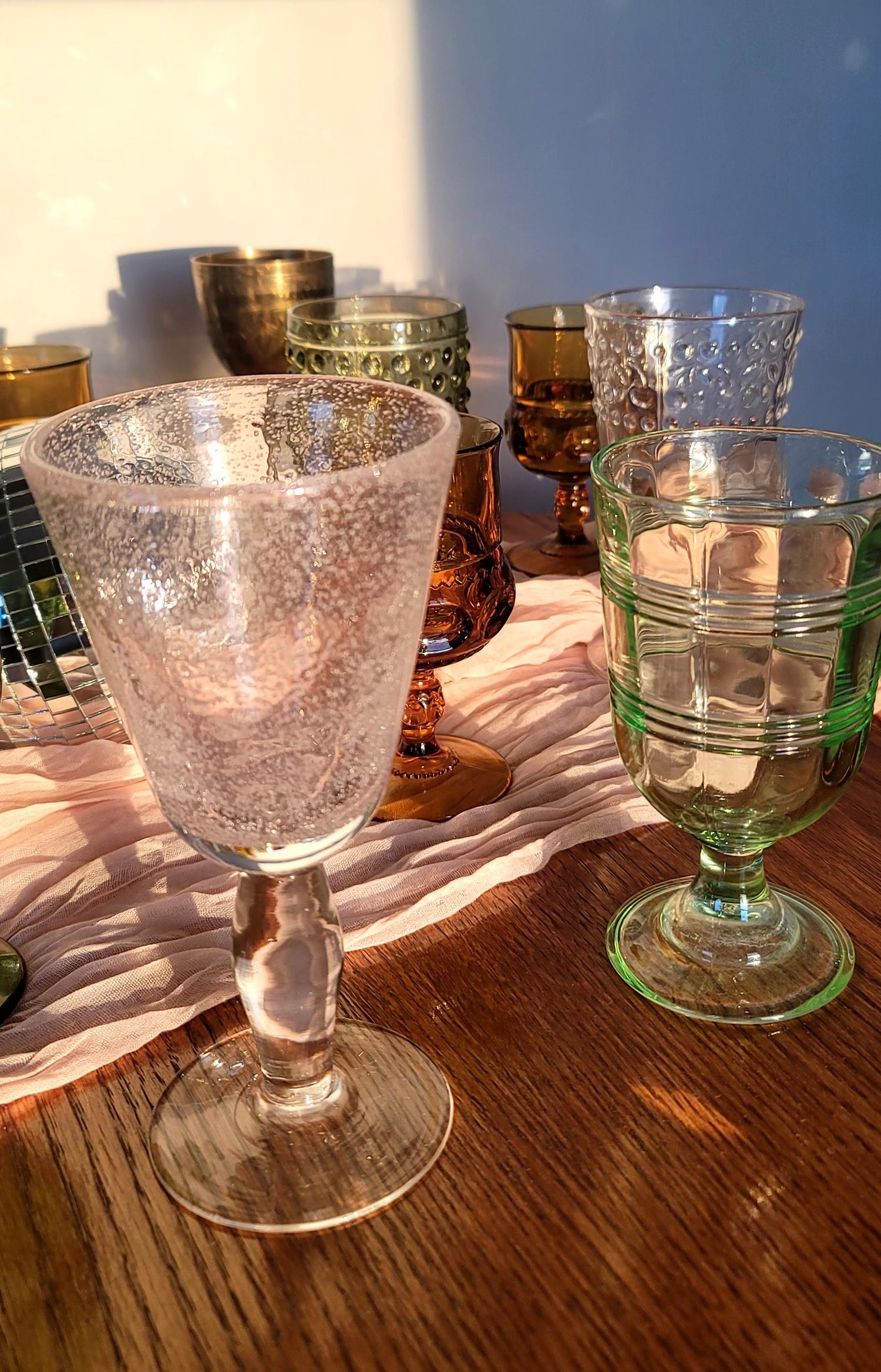 Assorted vintage glassware in a variety of colours, available for rent in Winnipeg & surrounding areas. Vintage glassware for rent. Vintage goblets for rent. Brass goblets for rent.